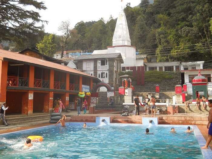 Open pool and Bhagsunag Temple in its backdrop in Dharamshala