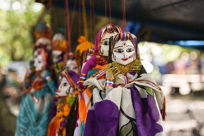 Rajasthani puppet dolls hanging from a cord at Chetak Circle in Udaipur