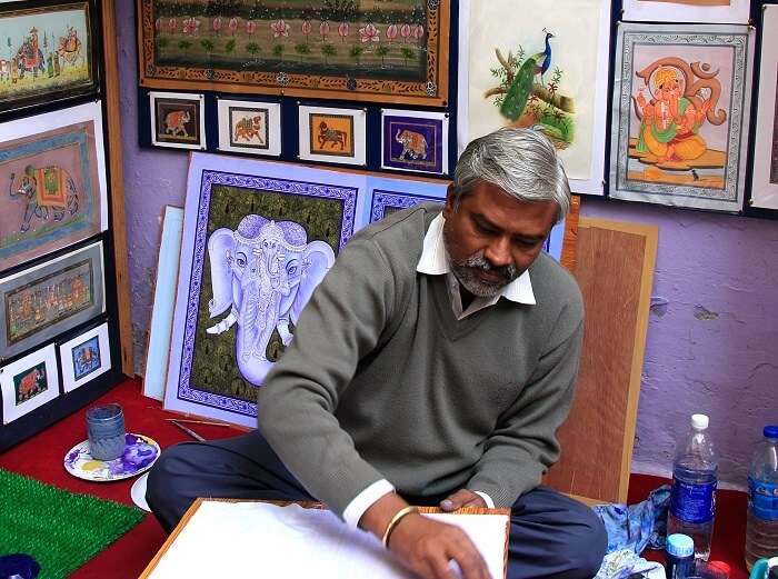 An artist sealing his thoughts on canvas at Hathi Pol Bazaar - One of the top shopping places in Udaipur