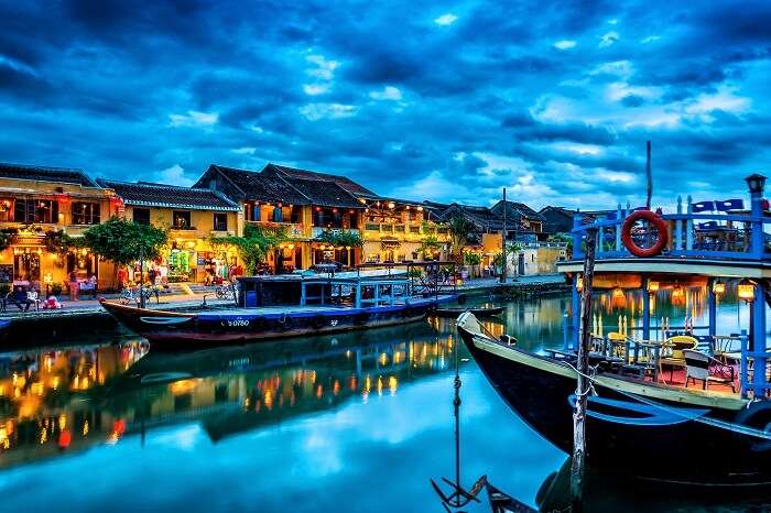 A beautiful view of the boat and shore of the canal in Hoi An Ancient Town