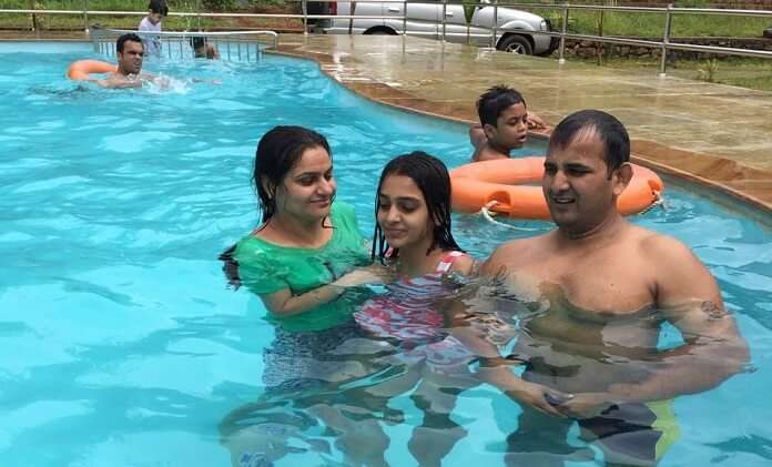 Ravi and his family enjoy at the pool in Kerala