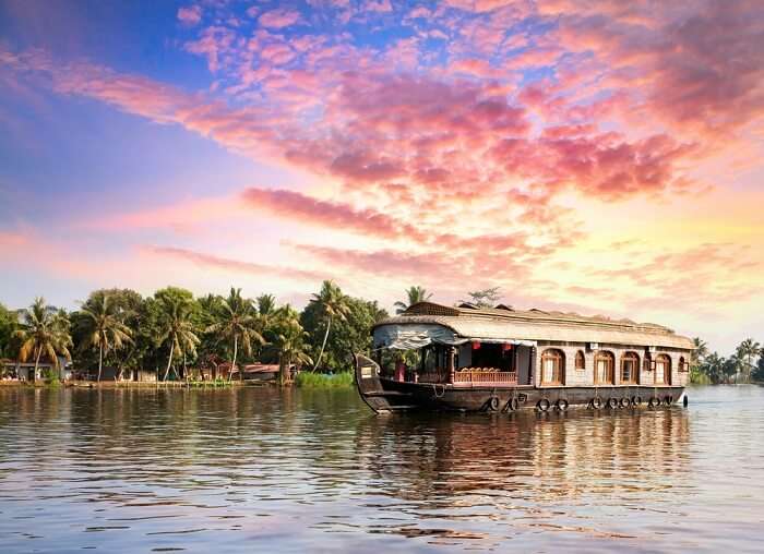A houseboat floating in the backwaters of Alleppey at dusk