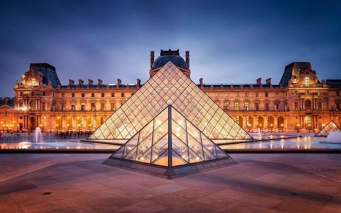 Glass exterior of The Louvre - the most popular art museum in Paris