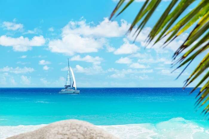 A shot from the Anse Georgette beach on Praslin island of a yacht in the blue waters