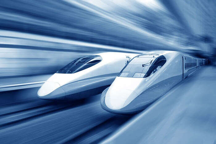Two modern bullet trains speeding with motion blur