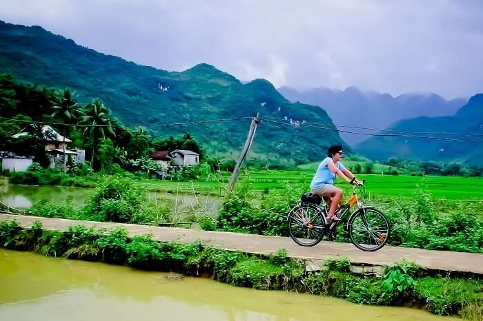 A tourist takes a cycling tour of Mai Chau