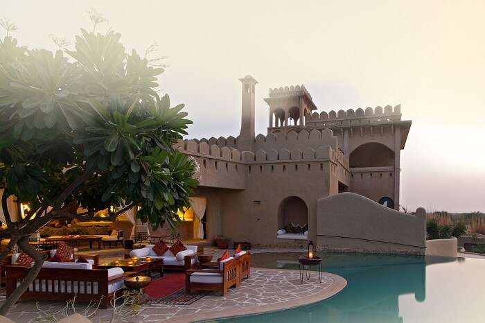 The sitting area by the infinity pool at the Mihir Garh House