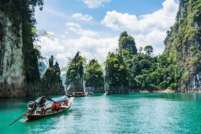 A group of travelers take a boat trip of the islands in Thailand