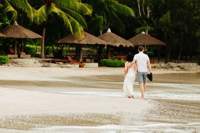 A couple walks on the shore at a beachfront resort in Vietnam