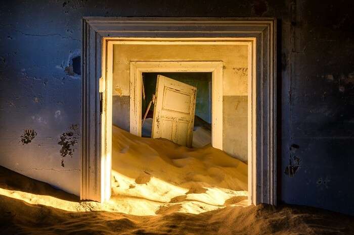 Building taken over by sand at the former diamond mining town of Kolmanskop in Namibia