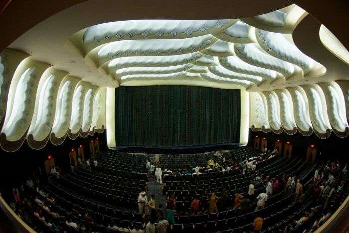 The opulent screening area of Raj Mandir cinema with velvet curtains on the screen