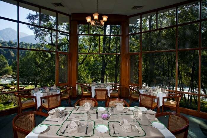 Restaurant at Span Resort & Spa with the backdrop of mountains and river