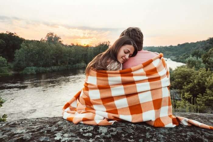 A couple enjoying the sunset on their honeymoon