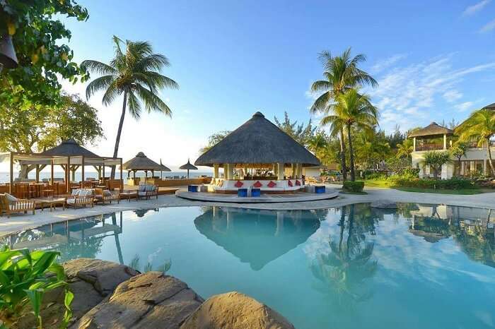 A beautiful shot of the swimming pool and the pool-side seating area at the Hilton resort in Mauritius