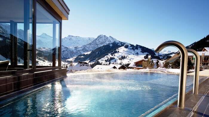 Pool in the background of icy mountains in The Cambrian, Adelboden, Switzerland