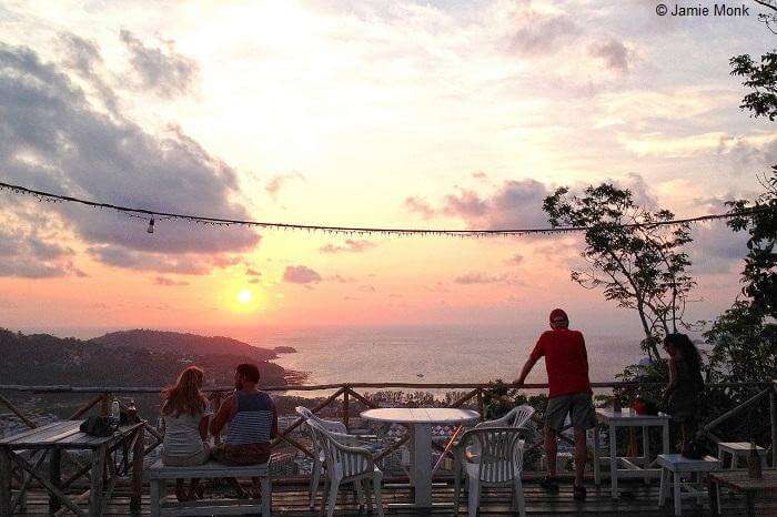 Guests relax and enjoy the sunset at the Wassa Homemade bar in Phuket