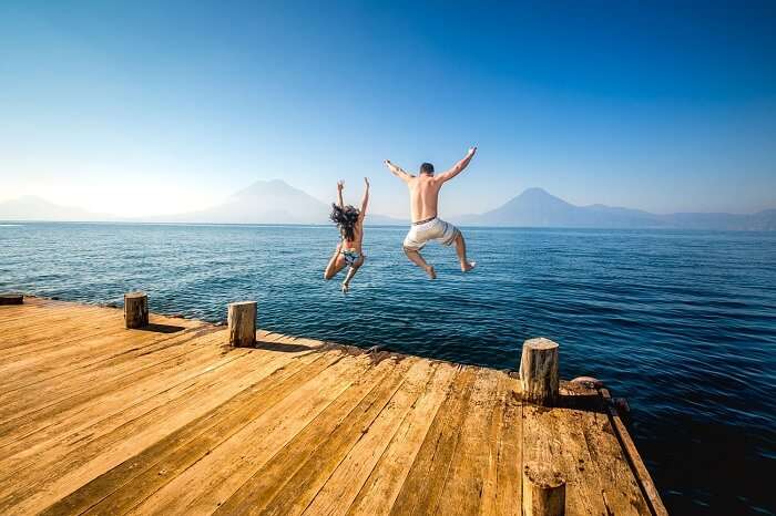 A honeymoon couple jumping into the at lake Atitlán in Panajachel