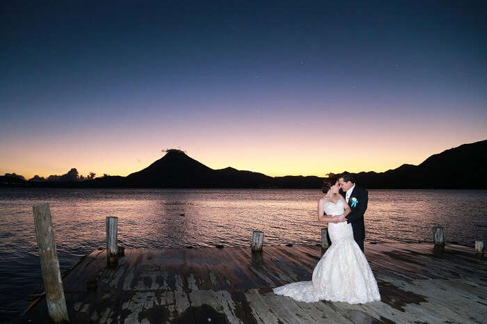 A honeymoon couple poses at lake Atitlán in Panajachel