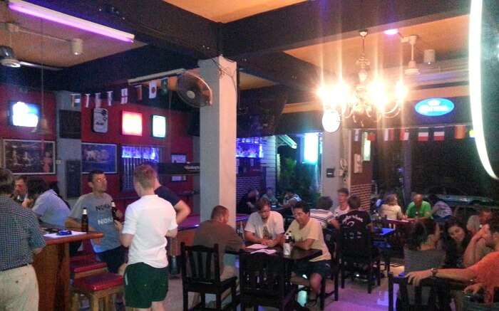 Tourists enjoying drinks at the Chilling Bar- a famous sports bar in Krabi town
