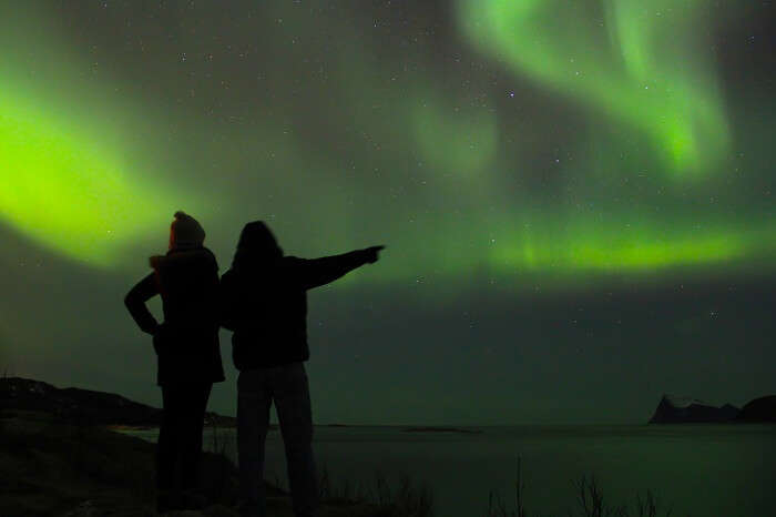 Couple braving the cold to watch the Northern lights in Lapland