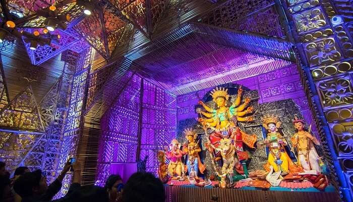 Locals gather in a pandal to celebrate the festival of Durga Pooja