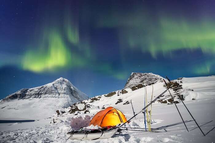 Camping under Northern Lights in Lapland