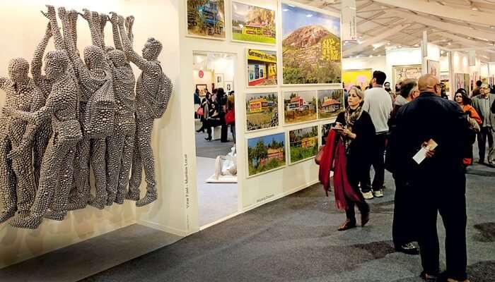 Art enthusiasts admiring the beautiful paintings and art pieces during the India Art Festival in Mumbai