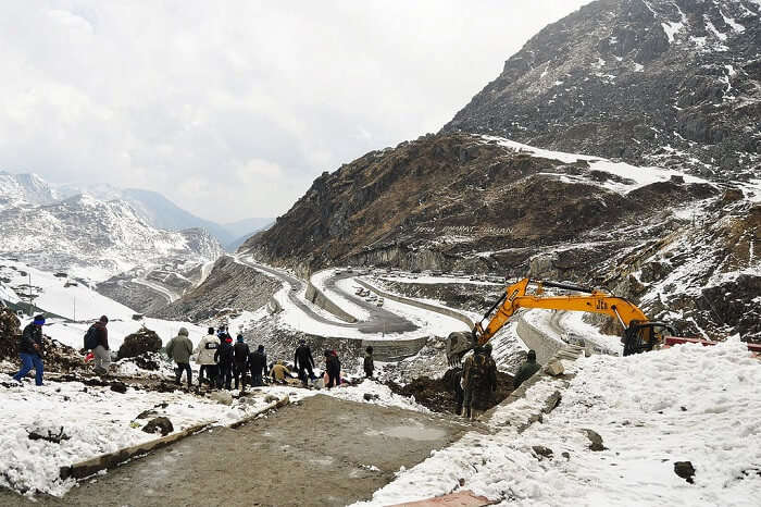 JCB removing snow from the zig-zag roads of Nathula Pass