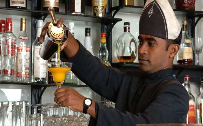 A bartender prepares a drink for guests at Le Garage nightclub