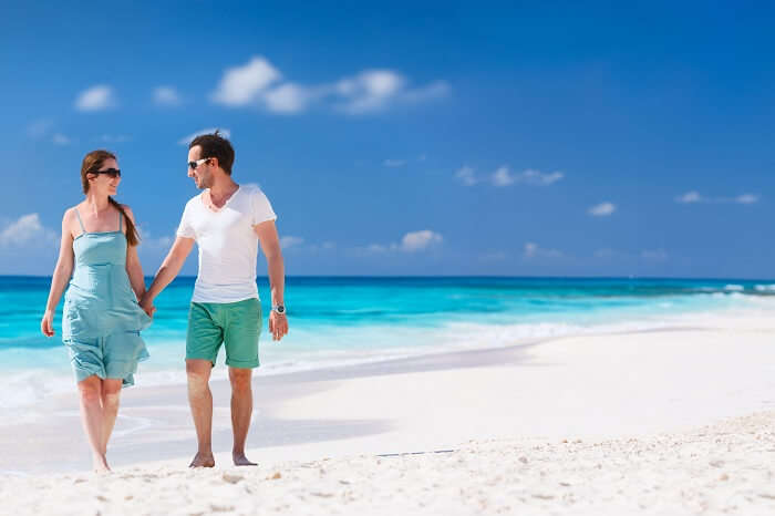 Panorama of a couple on a tropical beach at Anguilla in Caribbean