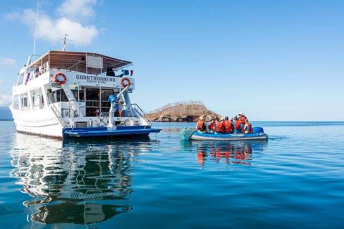 Tourists on a dinghy returning to a cruise ship in the Galapagos Islands