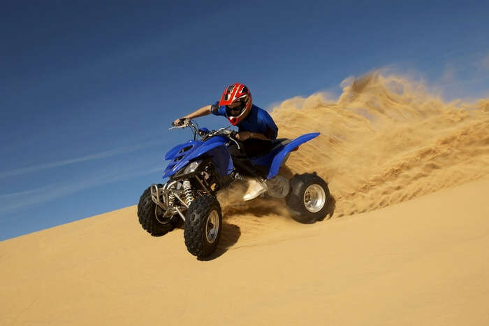 Man riding a quad bike near Sam Sand Dunes