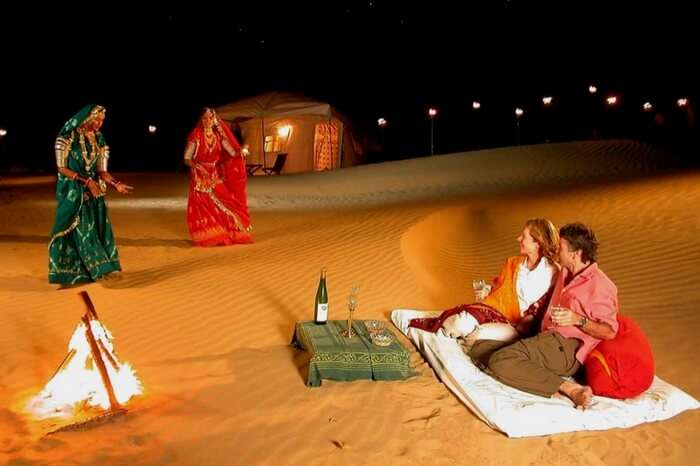 Tourists watching the Rajasthani folk dance in a camp at night