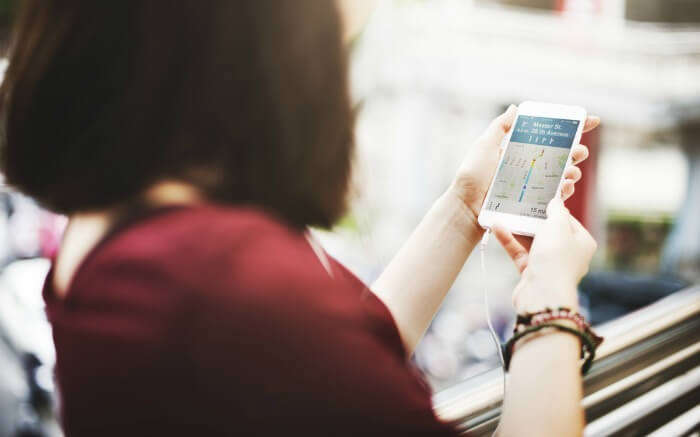 A woman using GPS on mobile for navigation