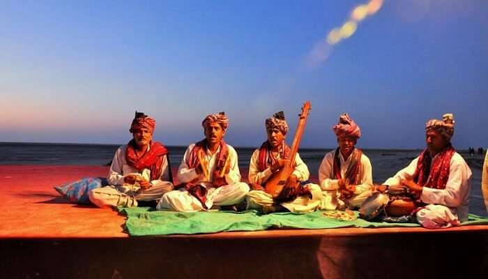Performers performing a folk song during the Rann Utsav