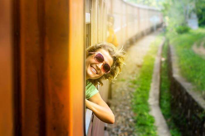 a happy kid in a train experiencing the joy of traveling