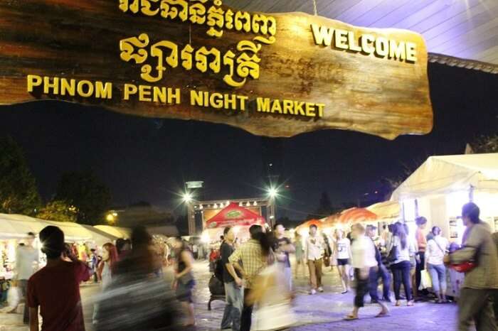 Tourists and locals walking through the Phnom Penh night market in Cambodia