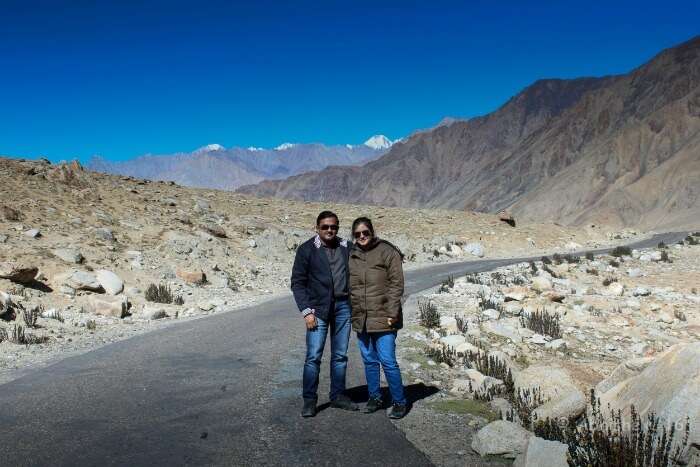 Abhishek and his wife posing before the Magnetic Hill on their trip to Ladakh