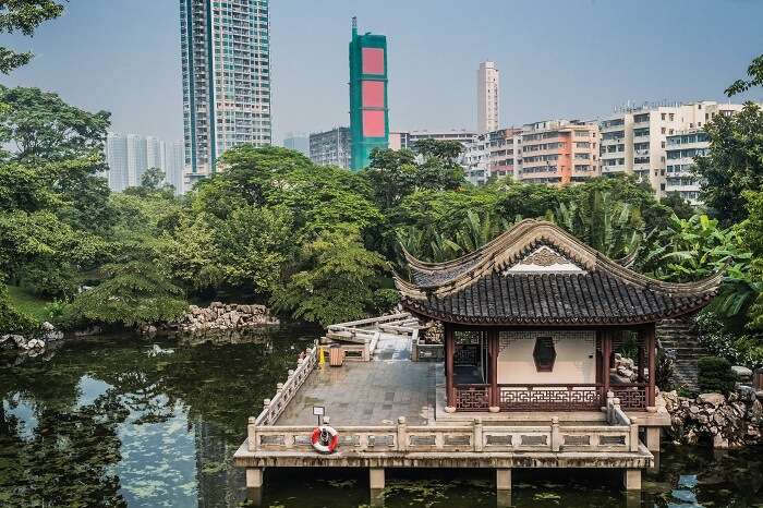 Pagoda temple by pond at Kowloon Walled City Park in Hong Kong