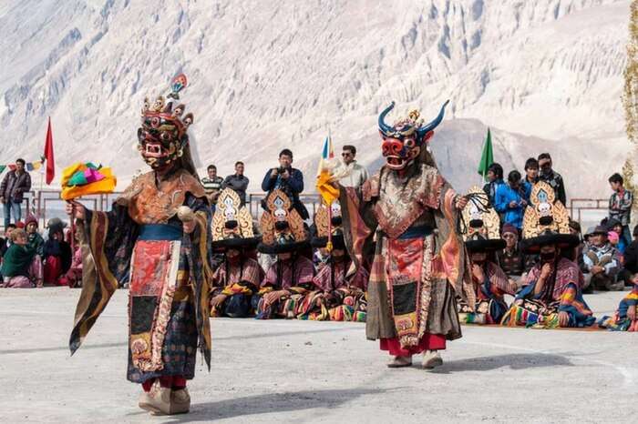 Masked dancers perform at Matho monastery in Leh