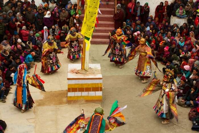 Masked dancers performing a sacred ritual during the festival