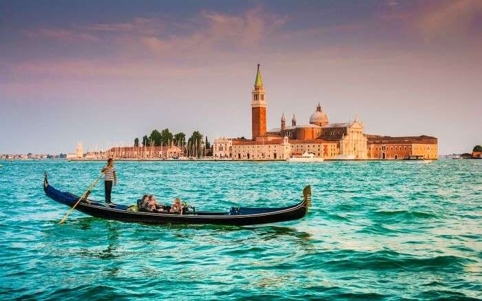 Panoramic view of a traditional Gondola on the Canal Grande with San Giorgio Maggiore Church in the background