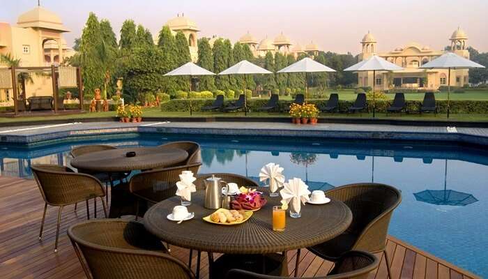 A snap of the swimming pool and the dining facility by the pool at Heritage Village Resort that is one of the best resorts in Manesar