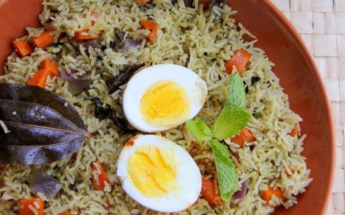 Jadoh rice served with boiled eggs top-view shot
