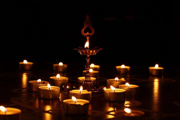 An array of diyas and a lamp lighted on the occasion of Karthigai Deepam