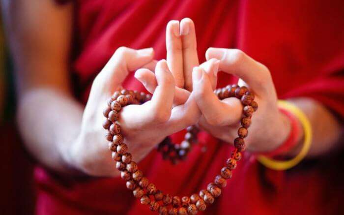 A monk doing the hand gesture that’s symbolic of offering - one of the main aspects of Losar Festival