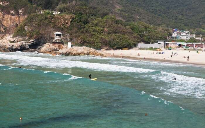 People chilling out and enjoying watersports at Tai Long Wan Beach