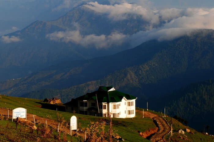 The beautiful guest house at Prashar Lake with Himalayas in the background