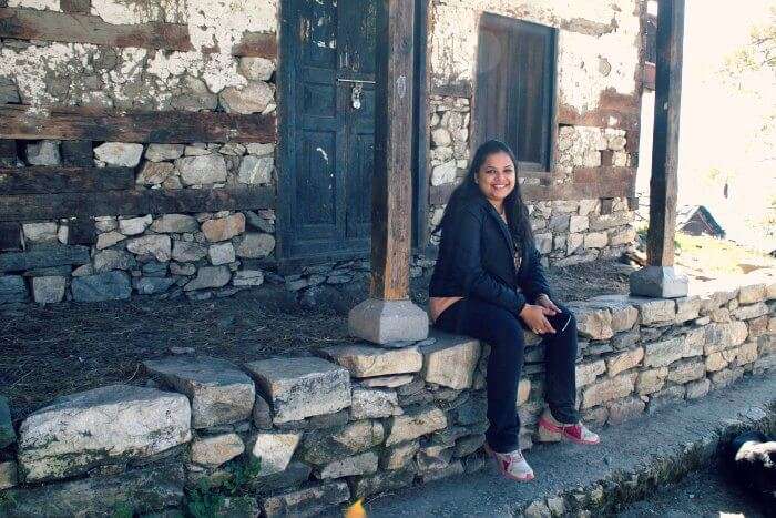 sitting near temple in tirthan