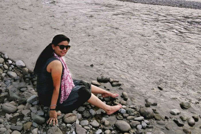 Sitting on the bank of the stream near the temple